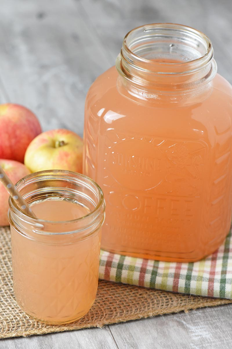 fresh homemade apple juice in Sunshine Coffee jar and jelly jar with paper straw