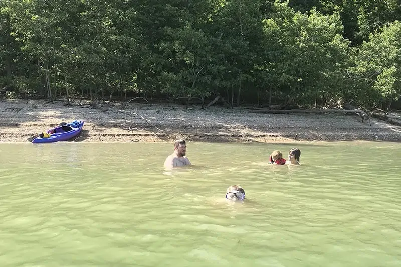 kids swimming with their dad in Beaver Lake in Northwest Arkansas