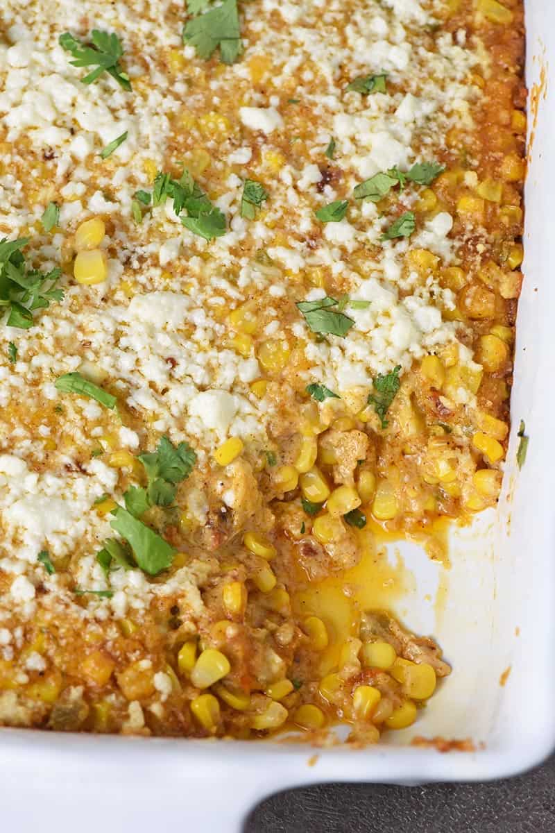 Mexican corn casserole in white baking dish, made with similar ingredients to Mexican corn on the cob