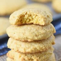 stack of soft pumpkin spice sugar cookies, made from scratch, on wood countertop with burlap cloth