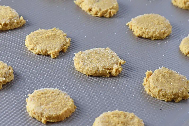mashed pumpkin sugar cookies with sugar on top, ready to bake on ungreased baking sheet