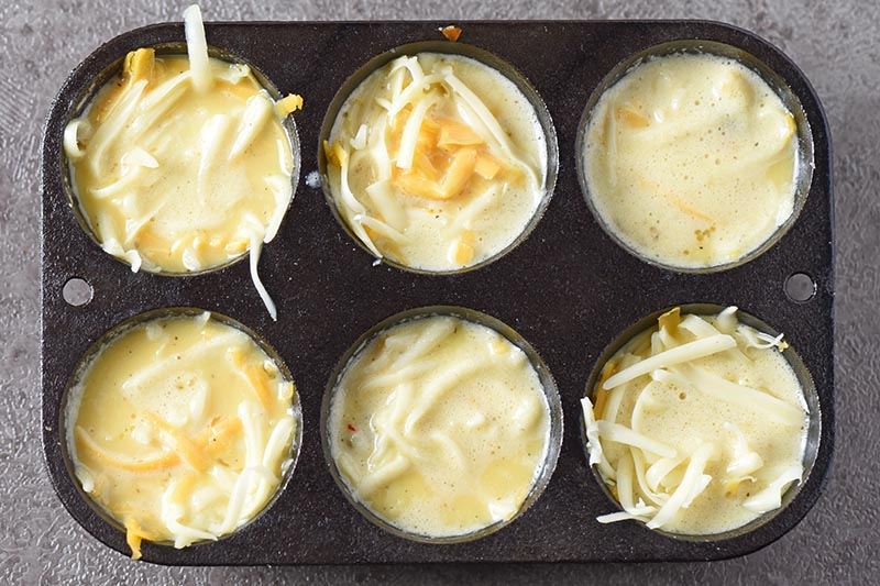 fill egg cups with egg mixture for easy sausage egg muffins