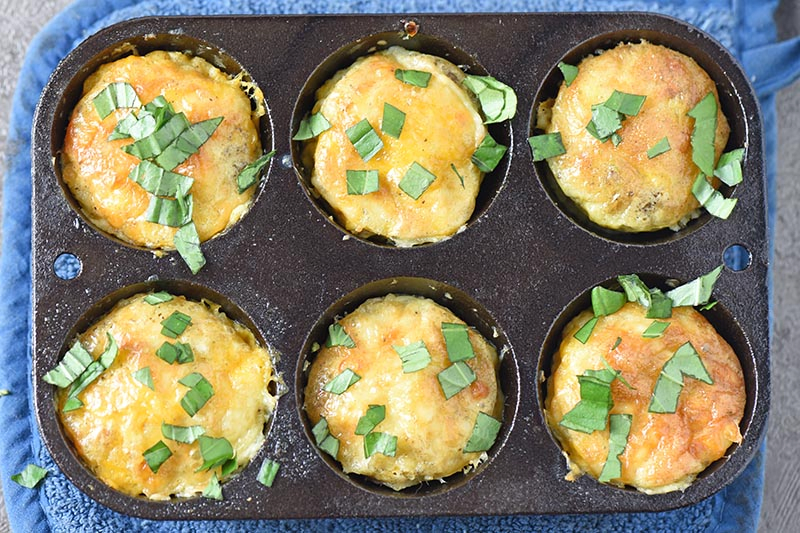 cooked sausage egg muffins in cast iron muffin pan