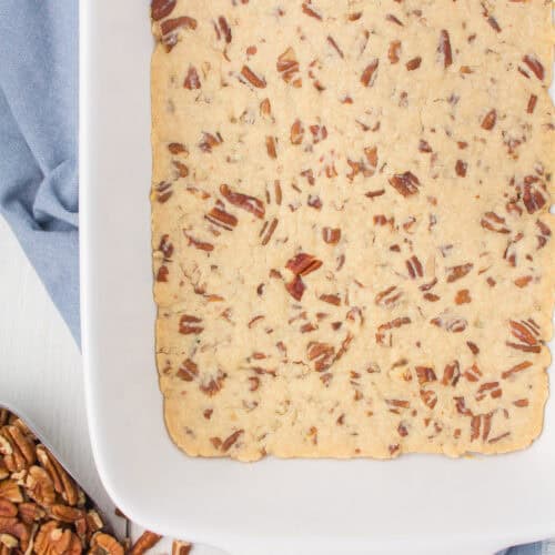 pecan crust for layered dessert in a white 9x13 baking pan