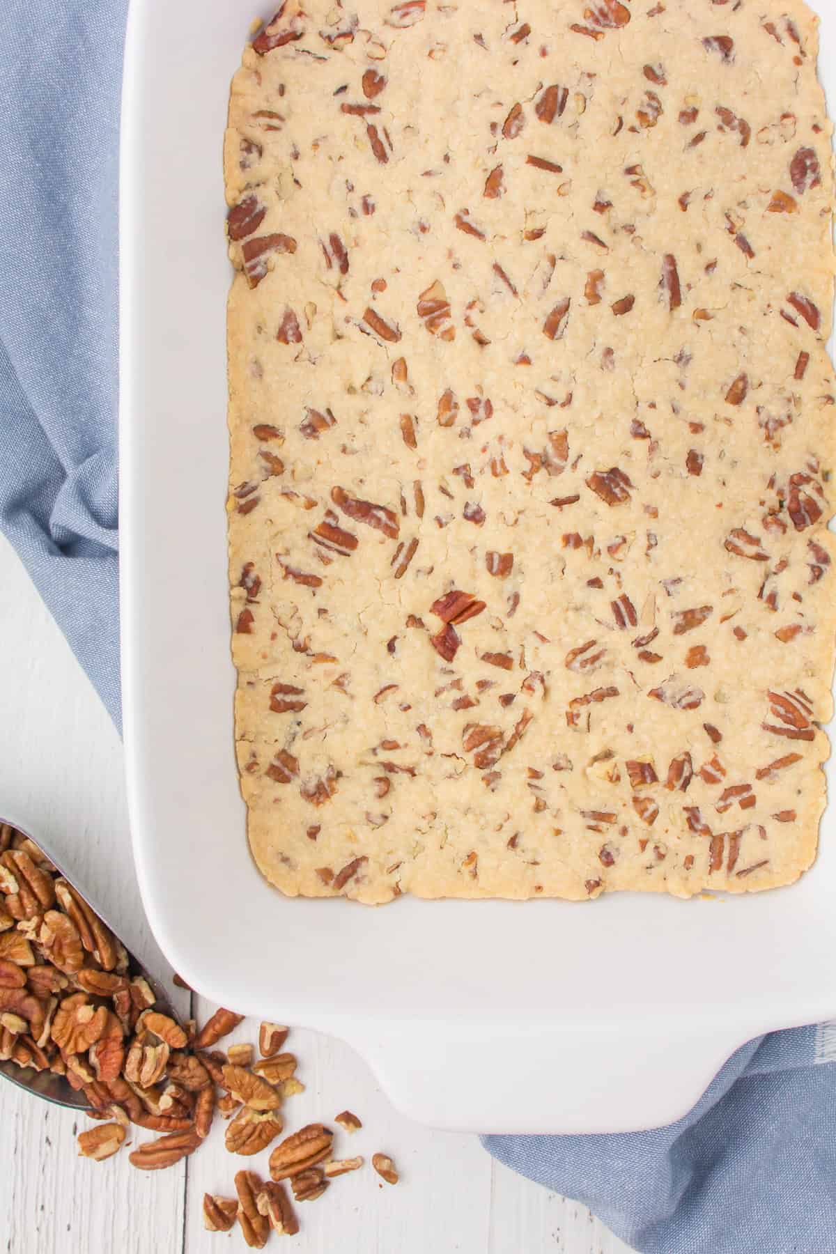 pecan crust for layered dessert in a white 9x13 baking pan
