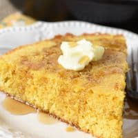 buttermilk cornbread with butter and maple syrup on white Pioneer Woman plate