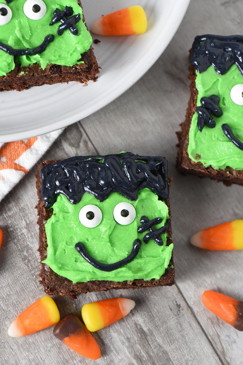 Frankenstein Halloween Brownies decorated for Halloween treats on wood with candy corn
