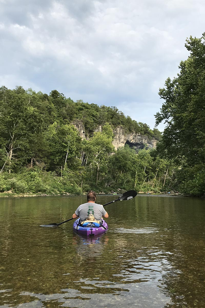 kayaking on Jacks Fork float trips, on the Alley Spring to Eminence float, looking up at a bluff side cave
