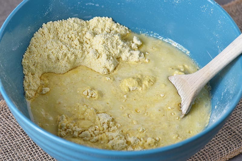 mixing wet and dry ingredients for homemade buttermilk cornbread recipe