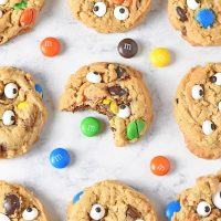 monster cookies with M&M'S candies on white marble countertop