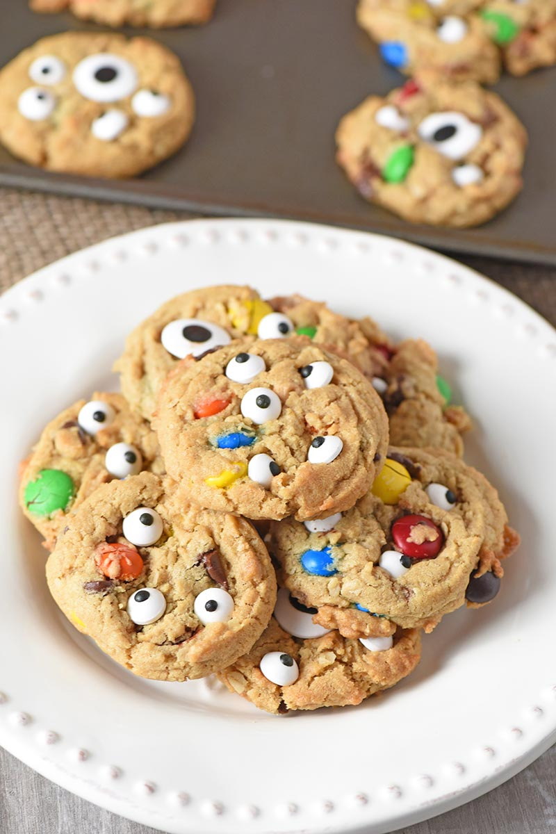 pile of Halloween monster cookies on a white plate