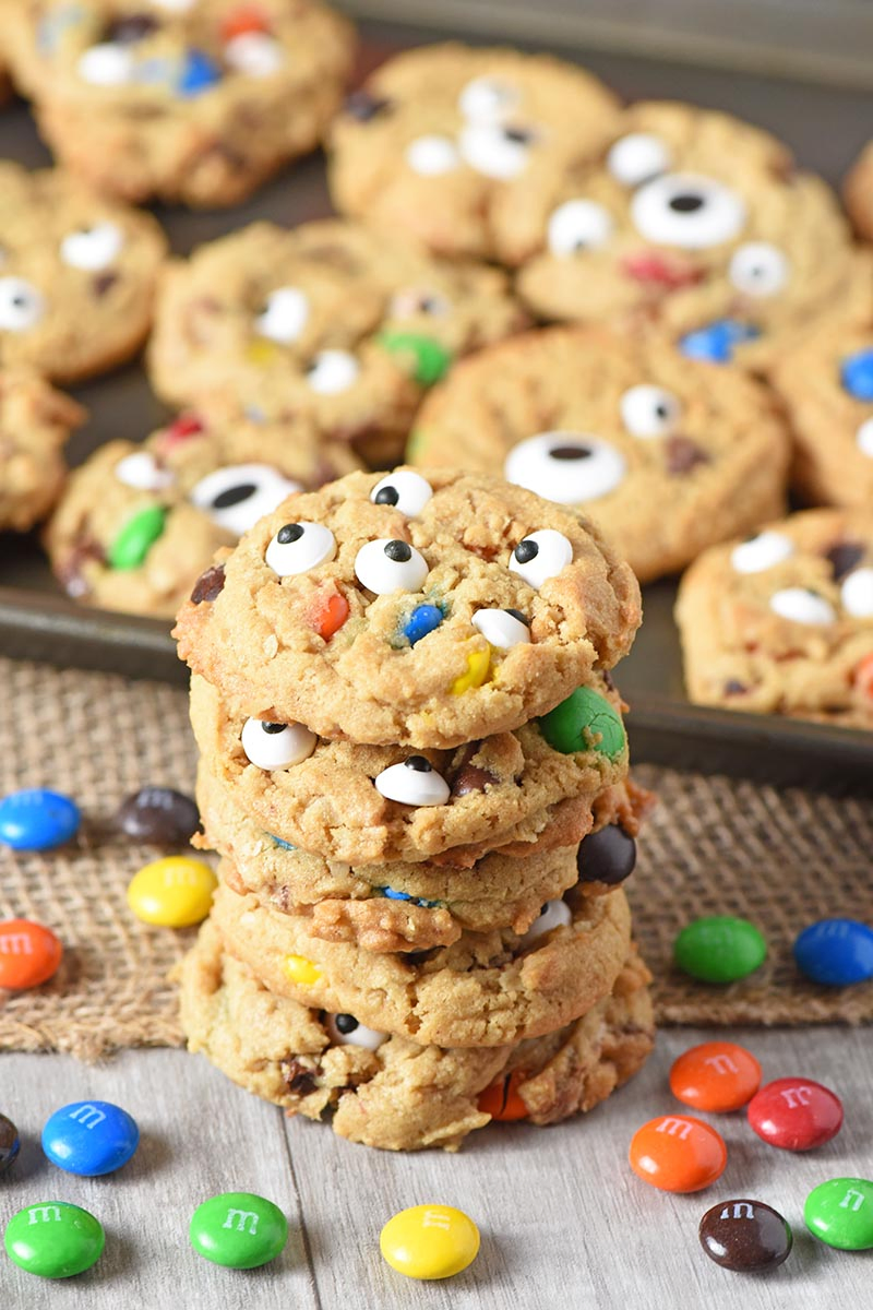 stack of monster cookies made with M&M'S and Halloween candy