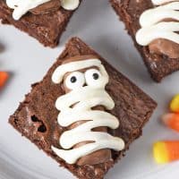 mummy halloween brownies made with Fun Size Twix bars on a plate with candy corn