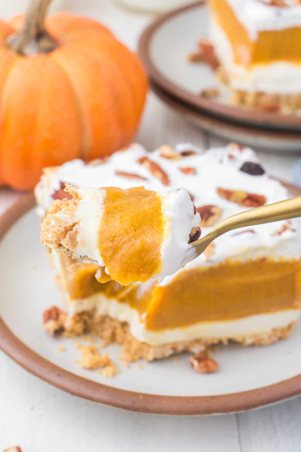closeup on a heaping forkful of creamy no bake pumpkin dessert