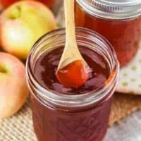 spooning apple jelly out of a jelly jar