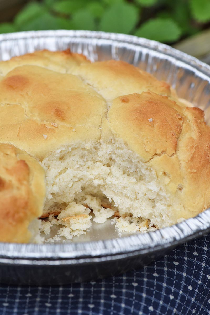 fluffy campfire drop biscuits in a tin foil pie plate