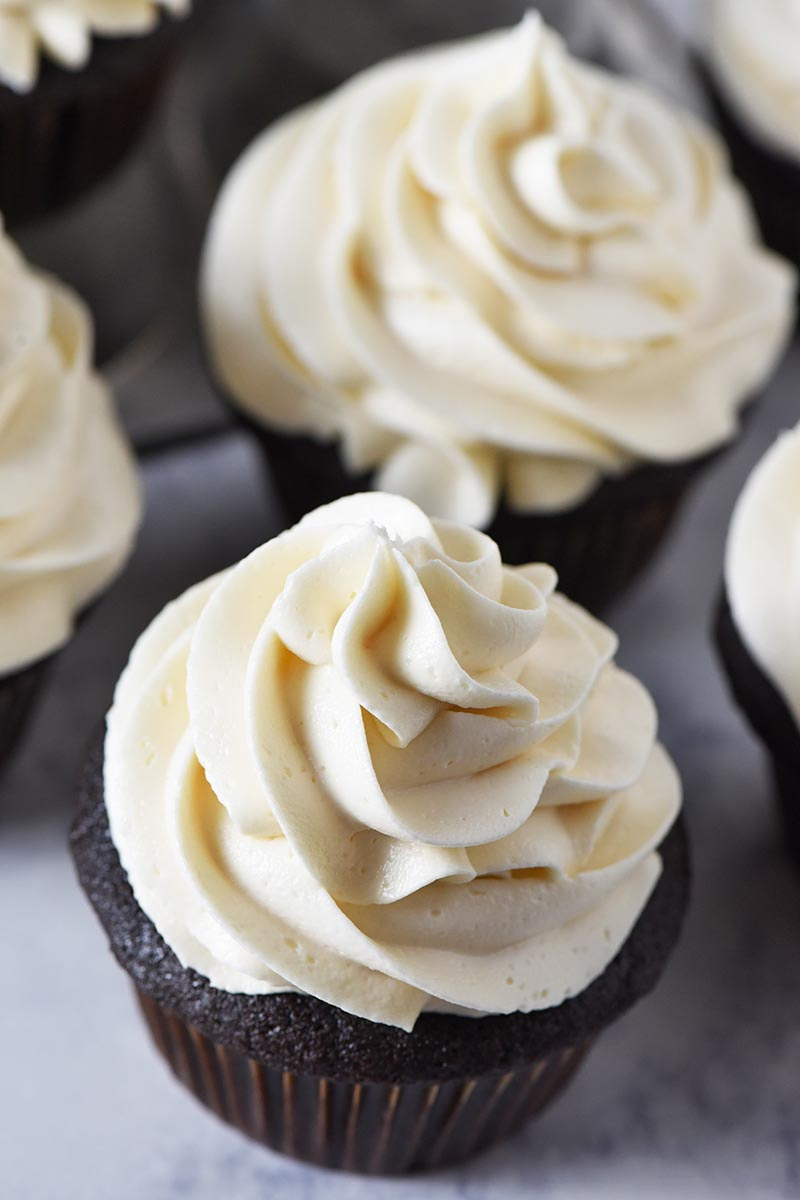 chocolate cupcakes topped with swirls of creamy butterbeer buttercream frosting