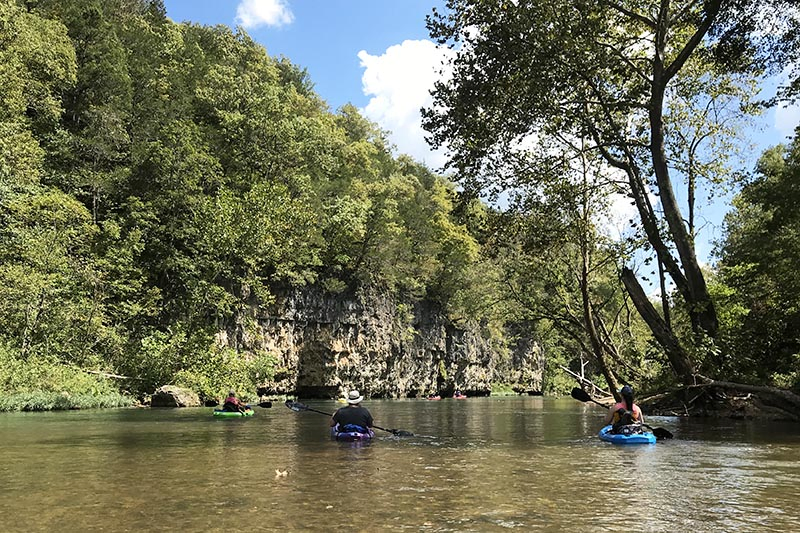 kayaking past bluffs on the Current River in Missouri