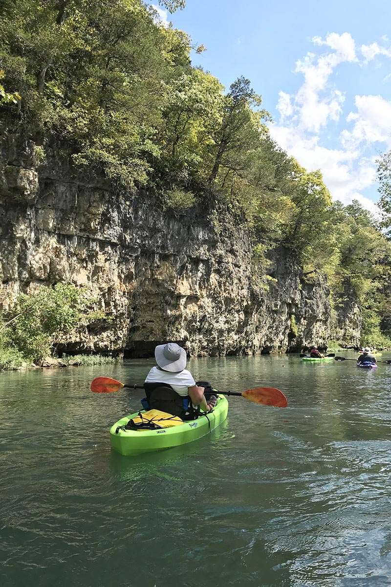 kayakers kayaking past bluffs on the Current River from Akers Ferry to Pulltite Campground
