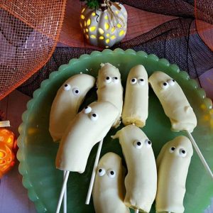 white chocolate banana ghost pops on green plate