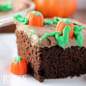 slice of pumpkin patch cake on white countertop with candy pumpkins
