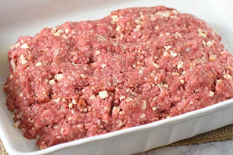 easy low carb meatloaf uncooked in a white baking dish