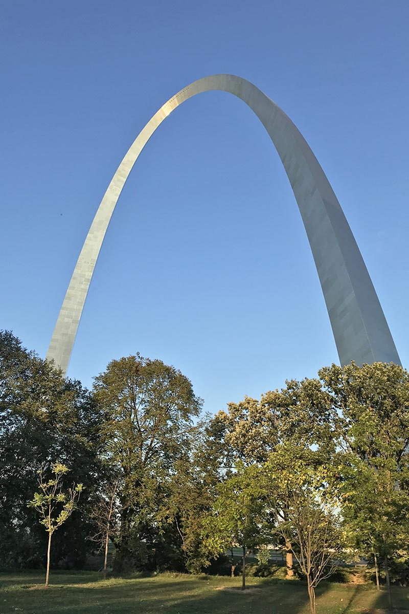 Gateway Arch National Park with tree lined pathways and grassy knolls in St. Louis, Missouri