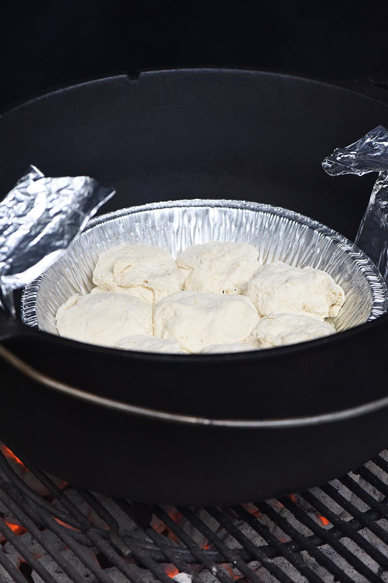 grilling Dutch oven drop biscuits while camping