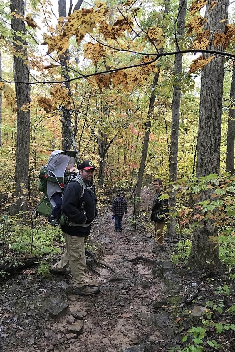 family hiking Hawksbill Crag Trail in Arkansas in autumn