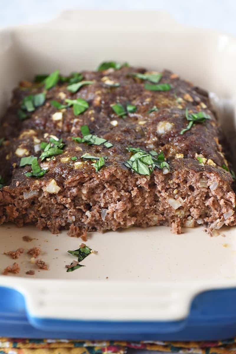 sliced homemade low carb meatloaf in blue baking dish