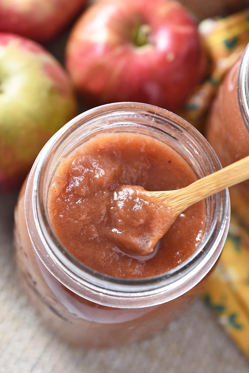 Instant Pot cinnamon applesauce in canning jar with small wooden spoon