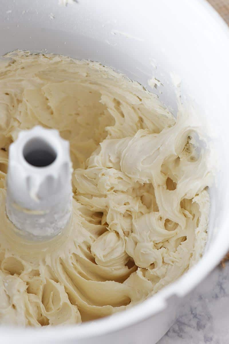mixing butterbeer buttercream frosting in white mixing bowl