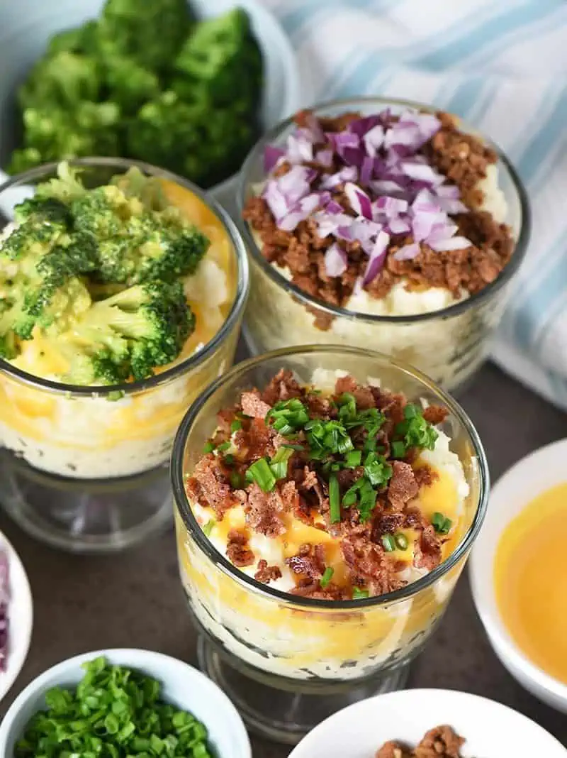 mashed potato bar toppings with small glass trifle bowls of mashed potatoes