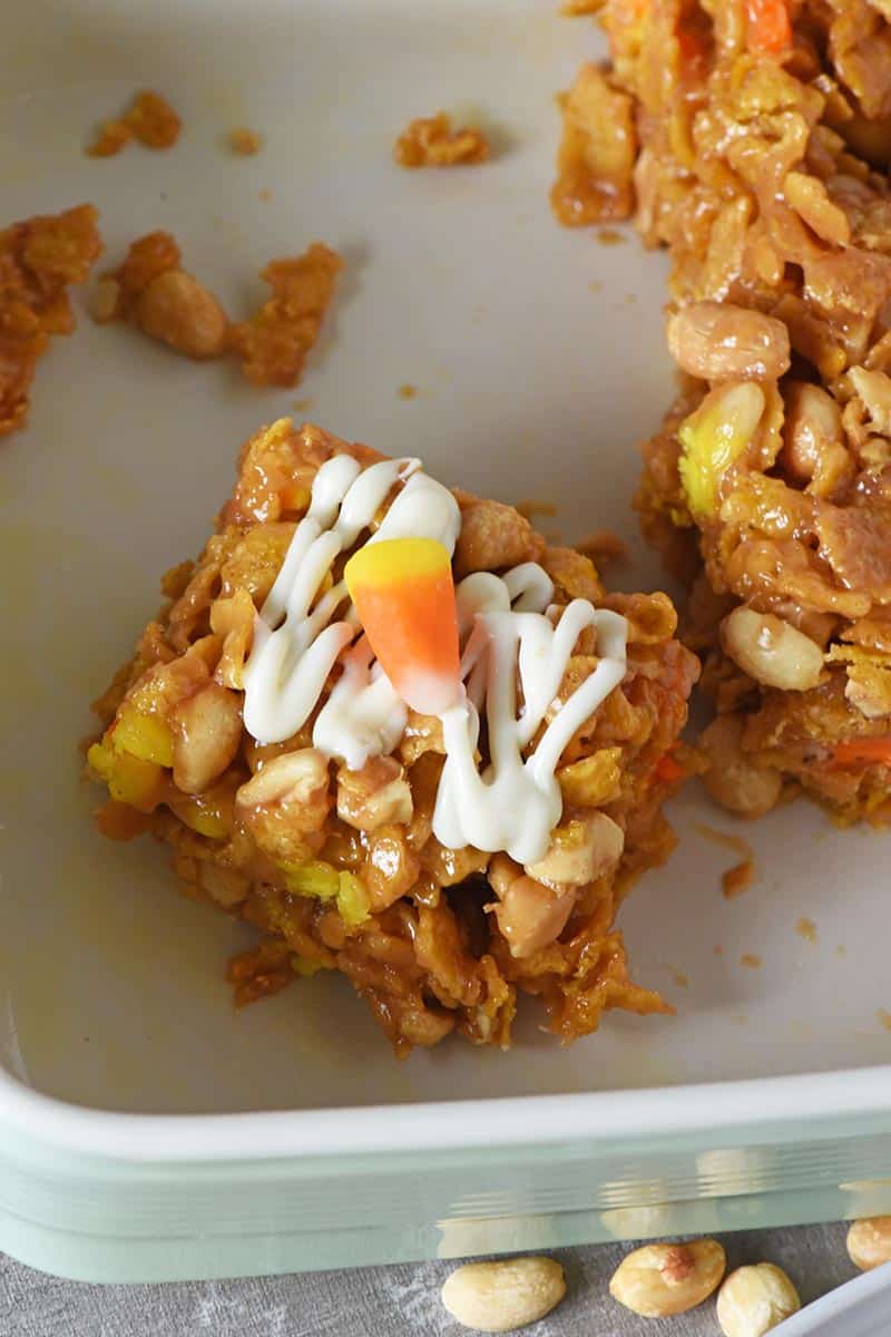 no bake Corn Flake squares with white chocolate drizzled on top and candy corn