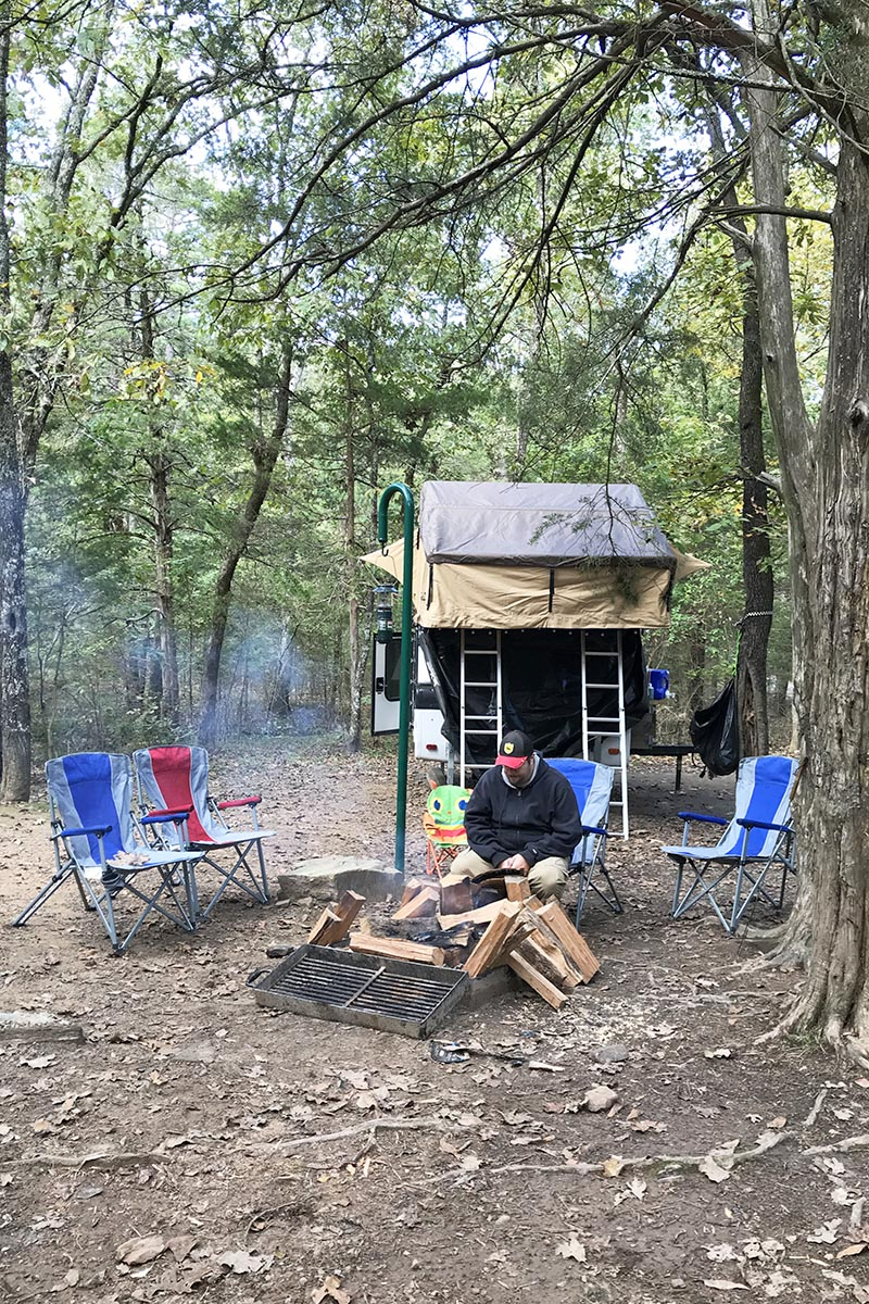 campsite in Petit Jean State Park campground with rooftop tent and campfire
