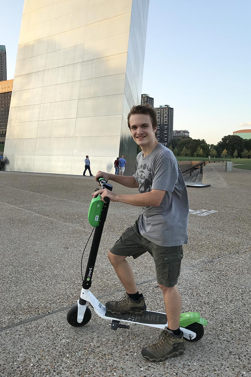 teen riding scooters in Gateway Arch National Park in St. Louis, Missouri