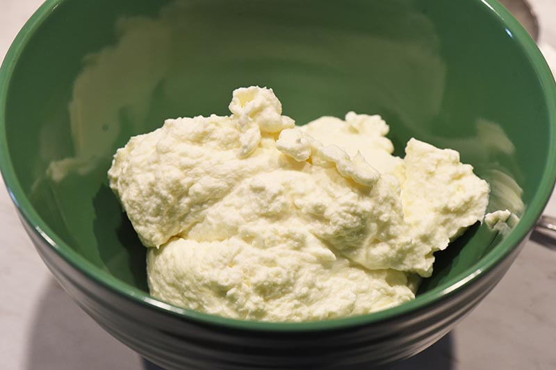 homemade whipped cream in green bowl for butterbeer recipe