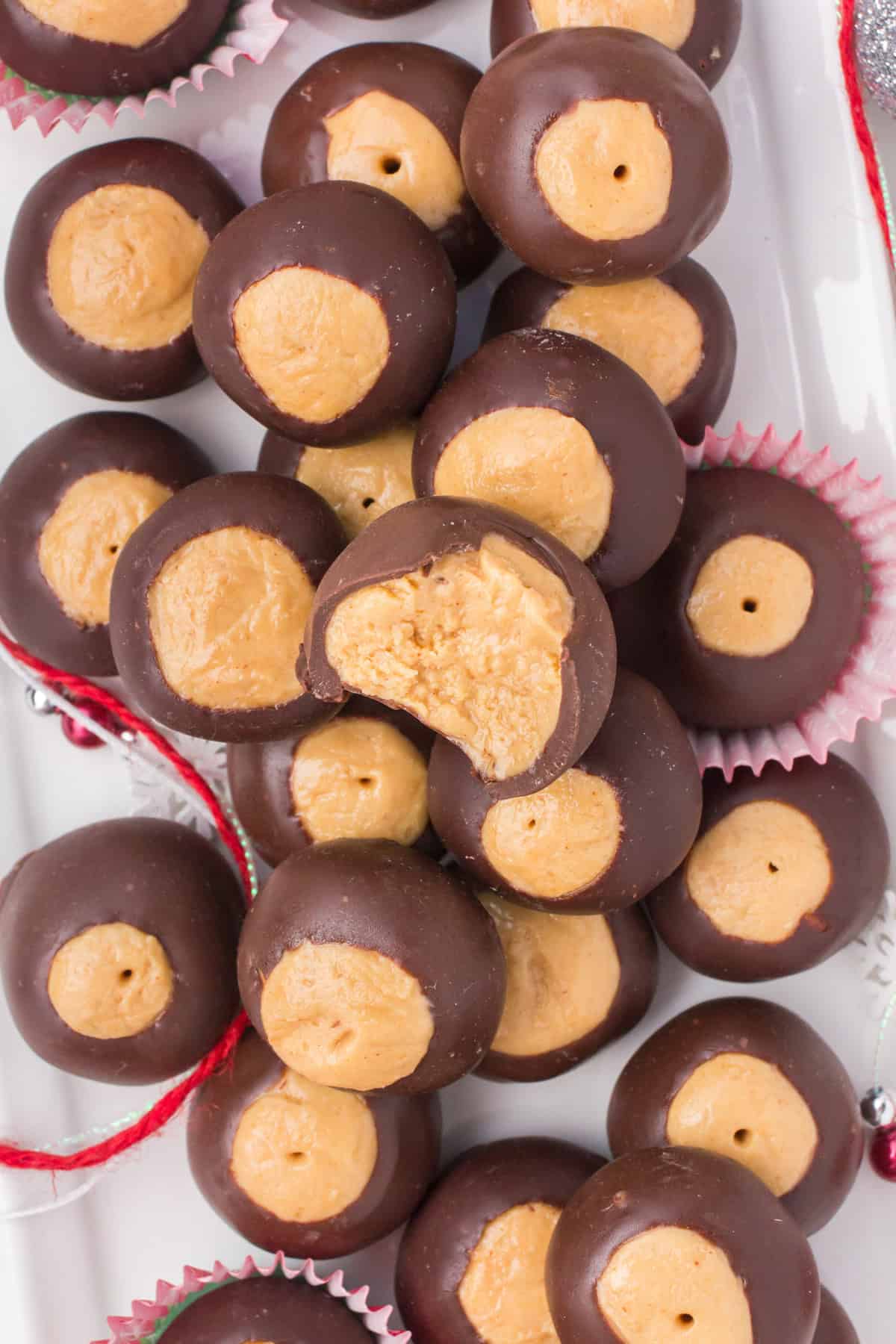 overhead shot showing a pile of buckeye balls with a bite taken out of one on the top
