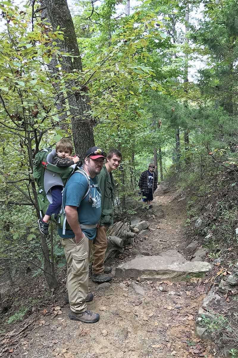 family hiking down Cedar Falls Trail in Petit Jean State Park
