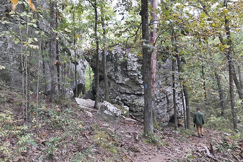 hiking around boulders on Seven Hollows Trail in Petit Jean