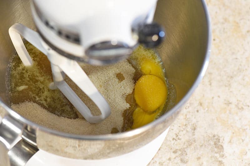 mixing ingredients for yellow cake from scratch with white KitchenAid stand mixer