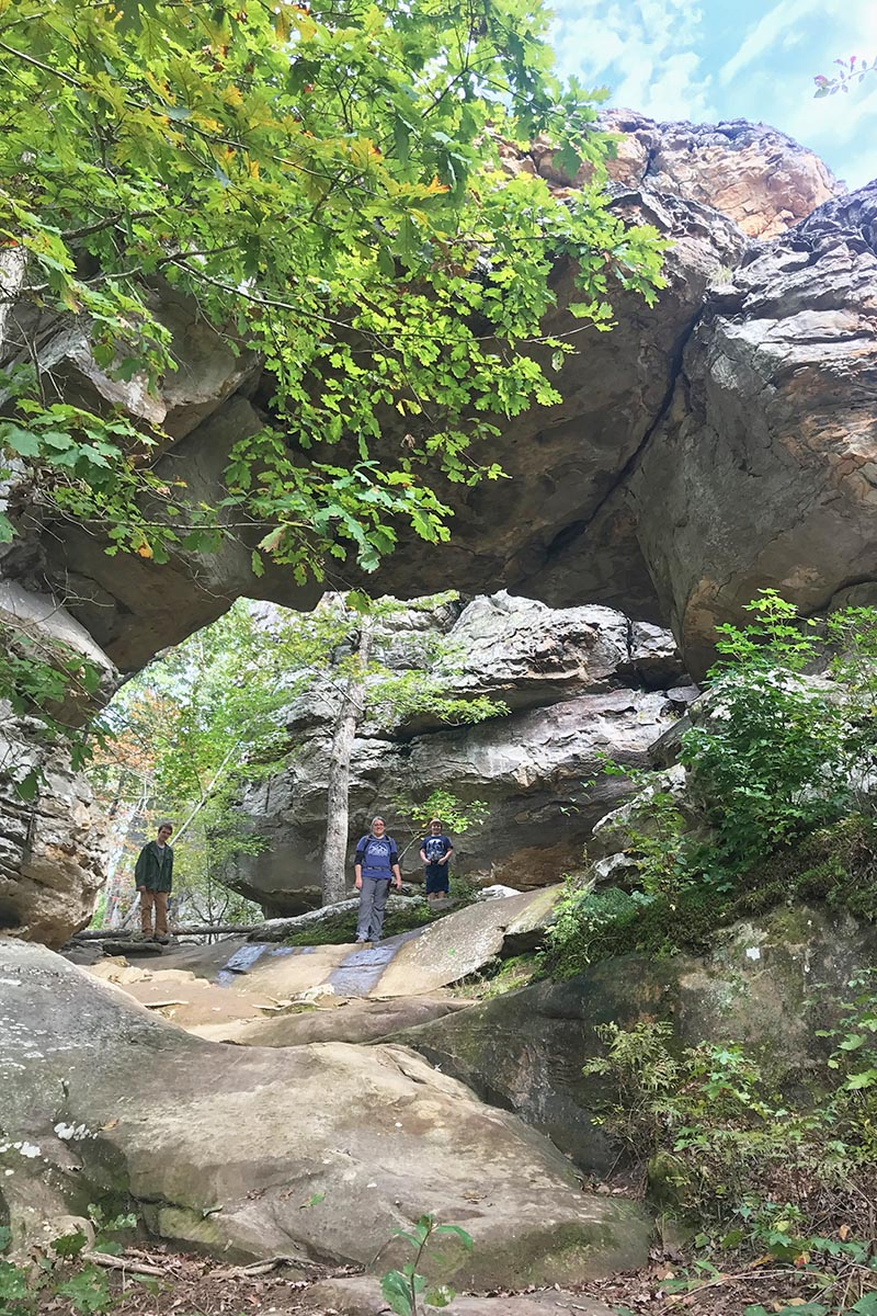 mom and sons at Natural Bridge on Seven Hollows Trail in Petit Jean State Park