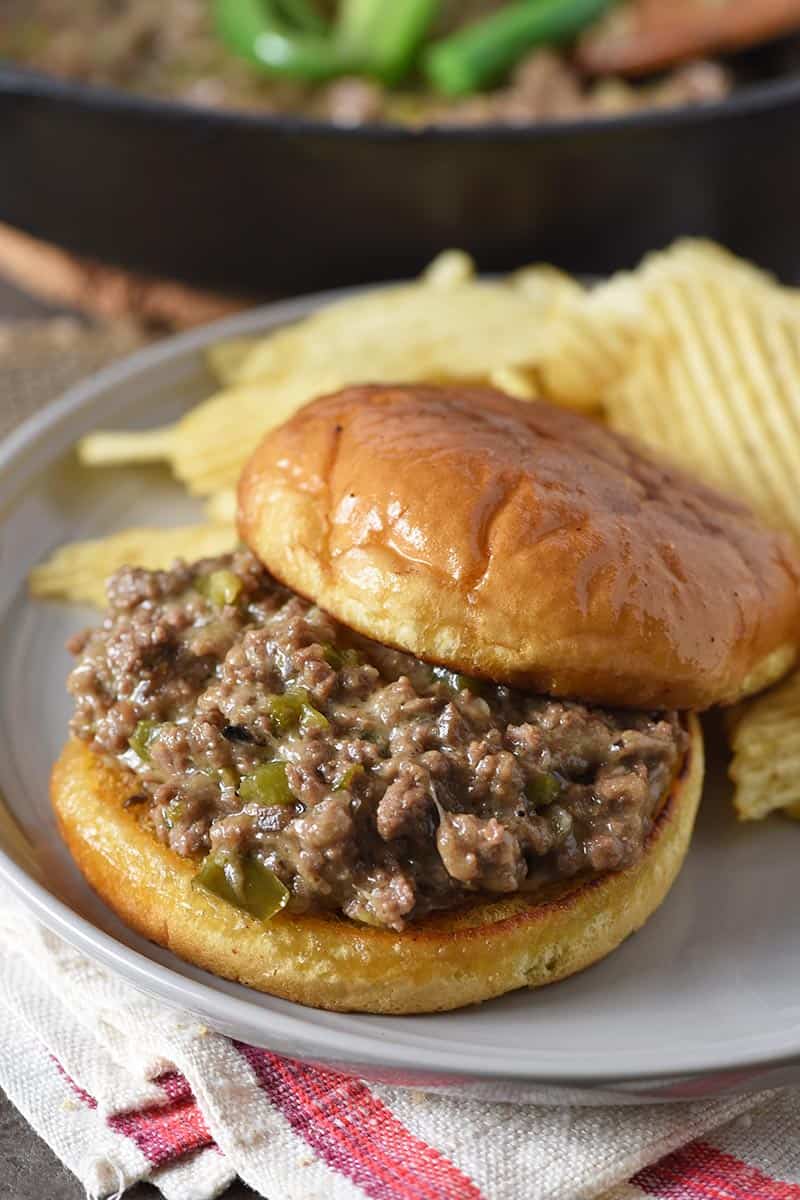 open faced Philly cheese steak sloppy joe on gray plate with potato chips