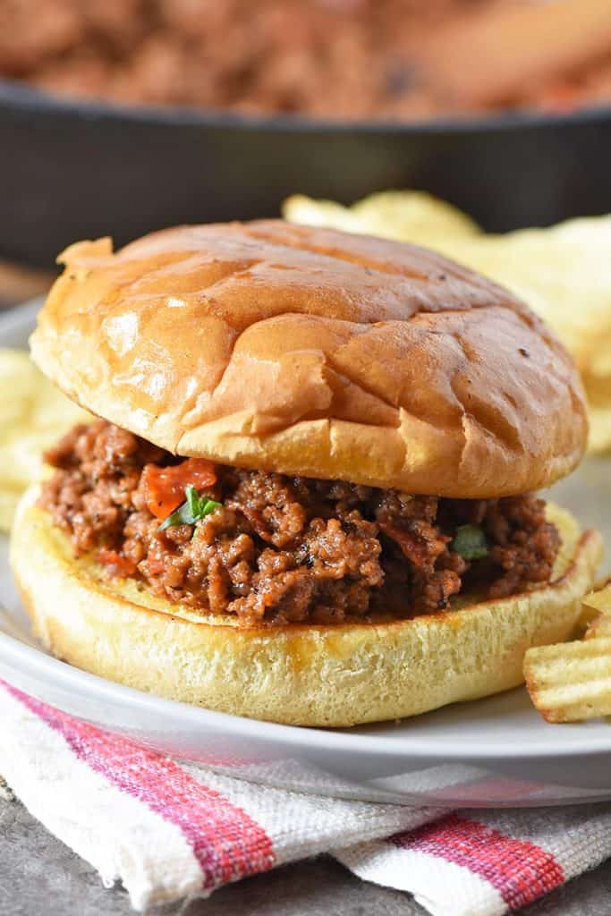 pepperoni pizza sloppy joes with toasted buns and potato chips on gray plate