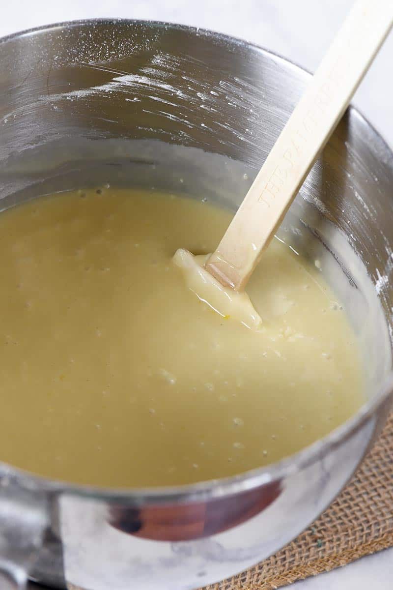 yellow cake batter in KitchenAid mixer bowl with white spatula