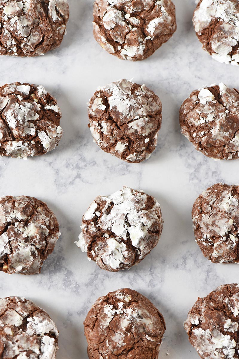 chocolate crinkle cookies baked and placed on white marble countertop
