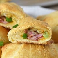 crescent rolls with leftover ham, stuffing, and cheese baked inside, stacked on a white plate