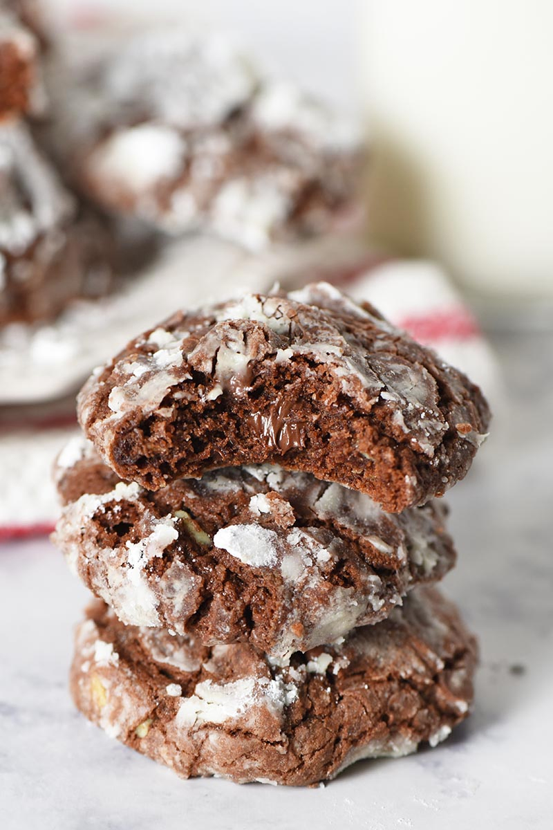 stack of chocolate mint crinkle cookies with bite taken