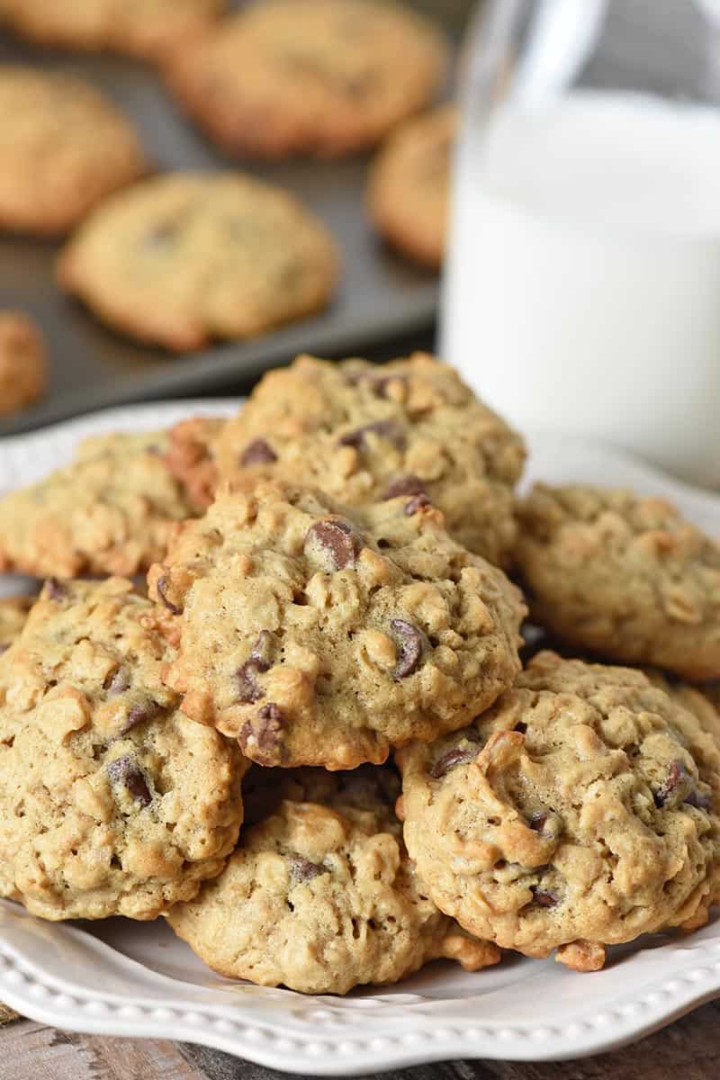 white plate of baked oatmeal chocolate chip cookies with milk