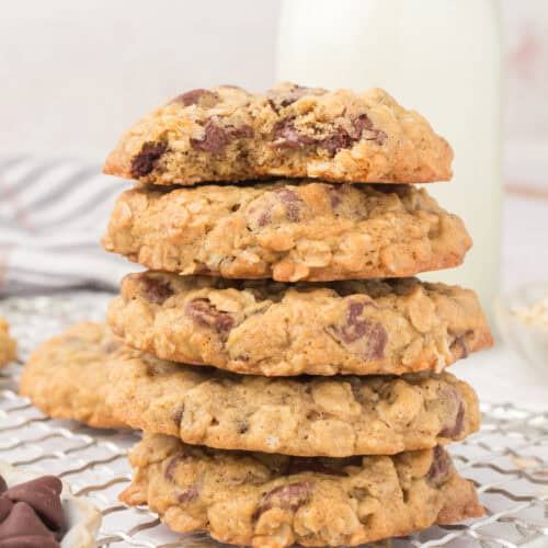 old fashioned oatmeal chocolate chip cookies stacked up with a bite taken out on top